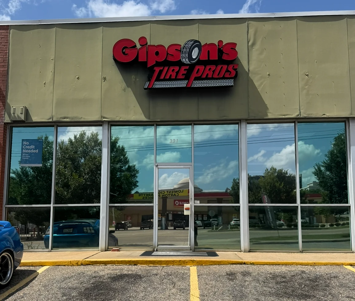 Reflective storefront windows at Gipson’s Tire Pros